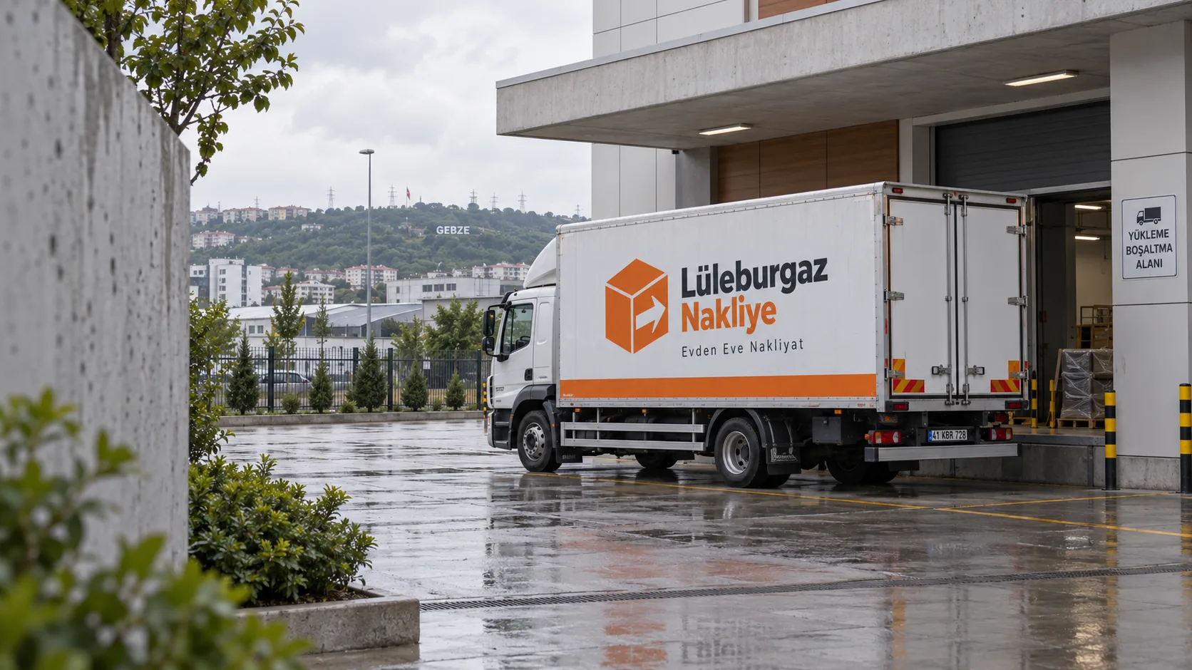 Yağmurlu havada bir tesisin yükleme rampasına yanaşmış Lüleburgaz Nakliye kamyonu